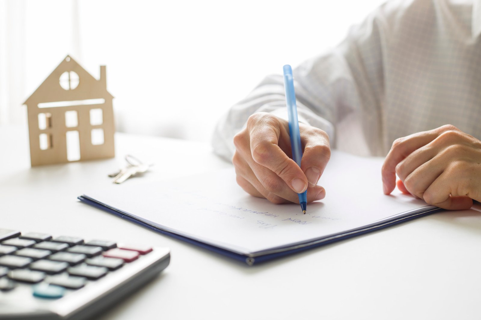 hand real estate agent signs house purchase document buying home